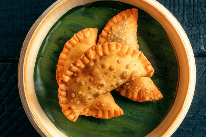 These half-moon-shaped filled pastries are Miami’s essential quick bite. Getting a cup of coffee in the morning? Pair it with a couple empanadas. Buying groceries? Stop by the grocer’s bakery and get an empanada to nibble while you shop. Having pizza and wine? Why not start with an order of empanadas? They can be fried or baked, range in size from bite-sized to taco-sized, and can be stuffed with whatever the maker feels like — meat, cheese, mushrooms, spinach, potatoes or, on the sweet side, fruit, cream cheese, Nutella, and the list continues. Upscale pan-Latin restaurants like Cvltvra do a great job packing big Latin flavors into the crunchy confines of an empanada shell. Take, for example, the perfectly crimped crescents filled with Venezuelan asado negro — wine-braised beef or veal.