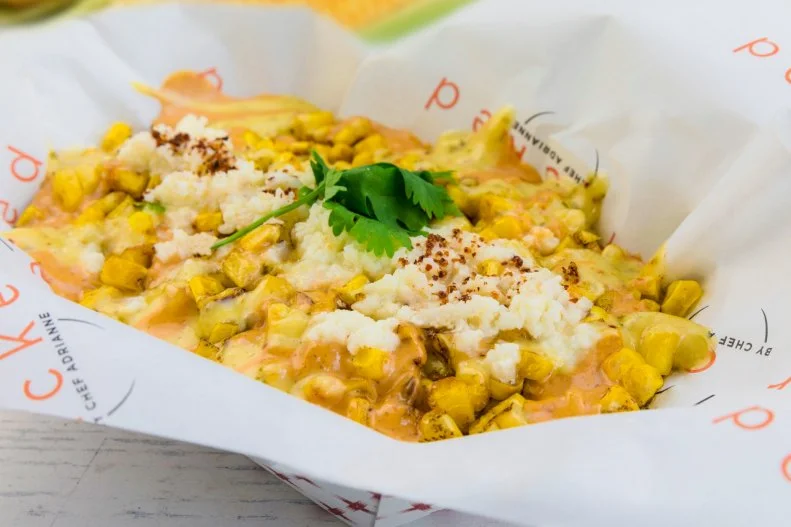 A popular Mexican street food, elote is ears of corn that are roasted or grilled, then slathered in garlicky mayonnaise or crema, sprinkled with cotija cheese and cilantro, and finally seasoned with chile powder and salt. The only down side of this veggie-friendly, savory and inexpensive snack that’s beloved around Miami is that it’s very messy to eat with your hands, which is usually the only option. Local chef Adrianne Calvo serves up elote from her Wharf stationary truck, with a simple but genius twist: She serves the corn off the cob.