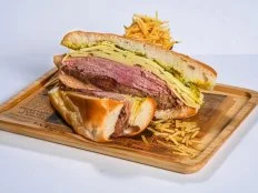 Ham, Swiss cheese, sliced roast pork and pickle chips are heaped two inches thick between thin slices of fresh Cuban bread, spread with mustard and butter; then the sandwich is grilled in a press, so the outside is crisp-toasted and the inside gooey with cheese. The Cuban sandwich is the ultimate ham and cheese melt, although no one can agree on who does the very best version. (In fact, there’s an annual festival and statewide contest.) Havana 1957 does an Americanized portion — i.e. too big for one person to eat,— with a side of fritas that practically demand you slake their saltiness with sangria.