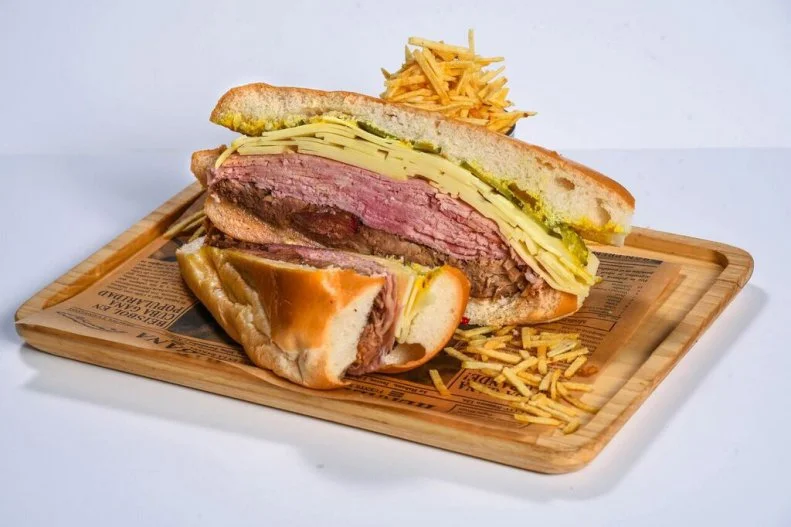 Ham, Swiss cheese, sliced roast pork and pickle chips are heaped two inches thick between thin slices of fresh Cuban bread, spread with mustard and butter; then the sandwich is grilled in a press, so the outside is crisp-toasted and the inside gooey with cheese. The Cuban sandwich is the ultimate ham and cheese melt, although no one can agree on who does the very best version. (In fact, there’s an annual festival and statewide contest.) Havana 1957 does an Americanized portion — i.e. too big for one person to eat,— with a side of fritas that practically demand you slake their saltiness with sangria.