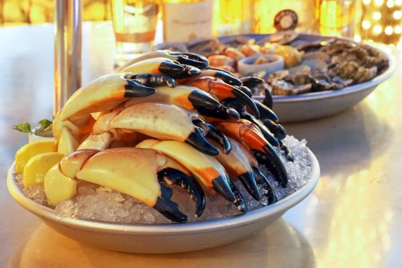 Ranging from large-ish to enormous, and so hardy that it takes a hammer to crack them, stone crab claws are a seasonal delicacy that seafood lovers never tire of. Most people never get their fill, perhaps because the price per claw is usually prohibitive, especially with the large ones. No matter the size, stone crab claws all have the same flaky but firm, salty-sweet meat, ideally with a creamy mustard dip to bring out that sweetness. The not-so-secret draw about Monty’s is that it serves a happy hour special of small claws for between $6 to $8 per piece, which is about half the market price, allowing seafood lovers to feast on stone crab without running up a restaurant bill higher than their car payments.