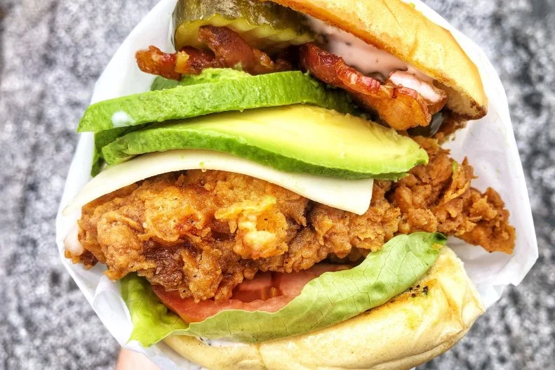 Miami International Airport, Concourse D, Near Gate D22 

Keep the easy-going beach-bite dreams alive on your return from Miami with a fried chicken sandwich from one of the city’s best spots. The same restaurant group behind uber-popular South Florida Southern-scratch cooking restaurant Yardbird brings some of their more casual fare to Spring Chicken, serving up chicken many ways including in the Country Club, with chicken (fried or grilled) Swiss cheese, bacon, tomato, pickles, and ranch (with a choice to add avocado) on a potato bun.