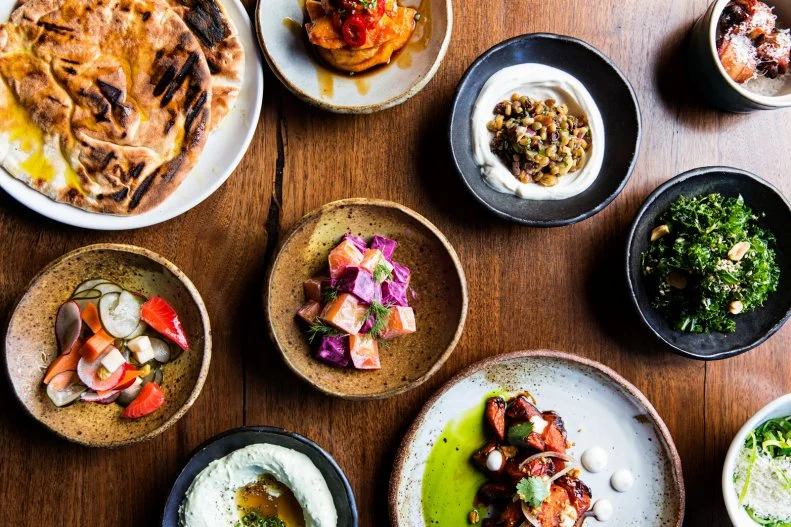 Opened in late 2015, the Nashville offshoot of Charleston restaurant Butcher & Bee puts a Southern spin on Middle Eastern cuisine. With exposed beams and decorative tiling, it’s a vibrant, airy room, but can feel intimate at the cozy bar or inside the spacious booths.  At the helm, Chef Bryan Lee Weaver crafts a menu of small and shareable plates, many of which tie together many regional cuisines. Carolina Gold crispy rice becomes the base for collard greens, avocado, peanuts, and chiles; local Bear Creek beef meatballs are set over a tomato and eggplant sugo. The whipped feta with fermented honey is a crowd pleaser, as are the mezze-sized bacon-wrapped dates.