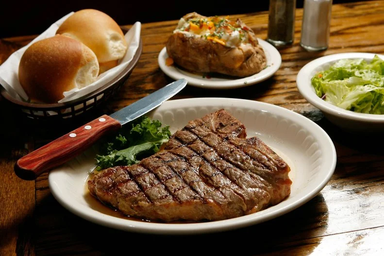 Set in Oklahoma City’s historic Stockyards City — named for the herds of cattle that passed through the area to satisfy growing demand for beef in the east — Cattlemen’s is the longest continually run restaurant in the city, open since 1910. It remains popular more than a century later for good reason. It boasts an authentic old-timey ambience with red leather booths and dark wood walls, and the steak is prepared with the same attention to detail as it always has been. Every piece of Midwest-raised beef gets sent through a needling machine for tenderizing including the famous Pepper Steak with peppercorn sauce and “Presidential Choice” T-Bone Steak, named after President George H.W. Bush, who ordered it on his visit to the steakhouse.