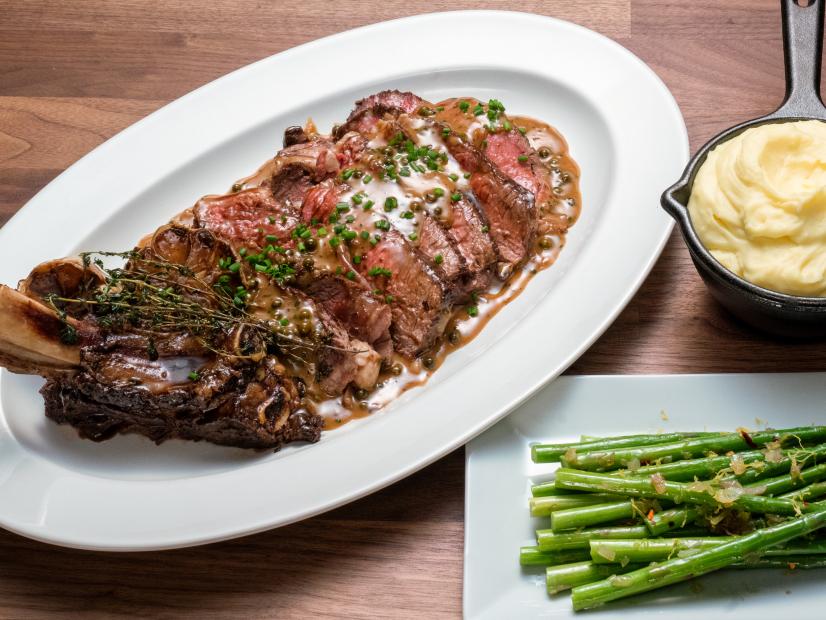 Hosts Tyler Florence and Anne Burrell's dish Rib Eye Steak with Peppercorn Sauce with Asparagus and Mashed Potatoes, during the Main Dish, Team Selection Challenge, Steak House, as seen on Worst Cooks in America, Season 16.