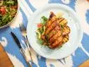 Robert Irvine makes Peach BBQ Chicken with Tomato Cucumber Salad and Sweet Potato, as seen on Food Network's The Kitchen  Season 21.
