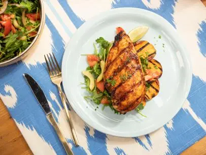 Robert Irvine makes Peach BBQ Chicken with Tomato Cucumber Salad and Sweet Potato, as seen on Food Network's The Kitchen  Season 21.