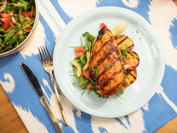 Robert Irvine makes Peach BBQ Chicken with Tomato Cucumber Salad and Sweet Potato, as seen on Food Network's The Kitchen  Season 21.
