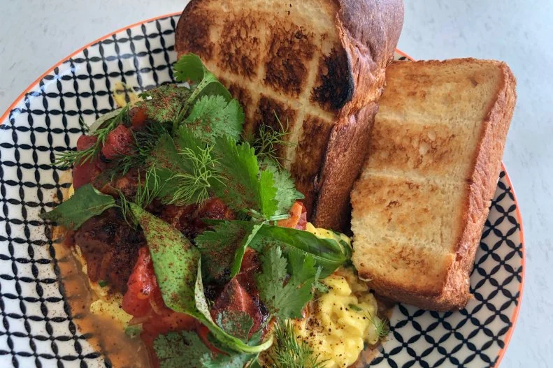 Scrambled eggs with tomatoes ended up on the menu at Breadbelly because it is a favorite family recipe from one of the cafe’s owners, and coincidentally the first recipe he learned to cook. A classic Chinese dish, scented with ginger, it balances sweet, salty and umami flavors. The juicy tomatoes and soft eggs are paired with thick slices of toasted milk bread. Breadbelly’s twist on the dish ($12.50) is addition of Chinese fermented black beans and a topping of fresh herbs, both of which make the dish even more appealing.