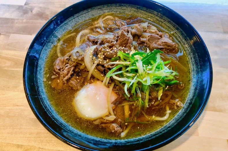 At Udon Time, follow the name and you’ll slurp slippery housemade udon noodles. The $14 signature bowl has sweet onions, ginger, green onion and wagyu chuck or a blend of heritage Berkshire pork from The Butcher Shop by Niku Steakhouse next door. It’s a luscious bowl of noodles swimming in a light and sweet savory broth. To make it even richer, add an egg for $1.