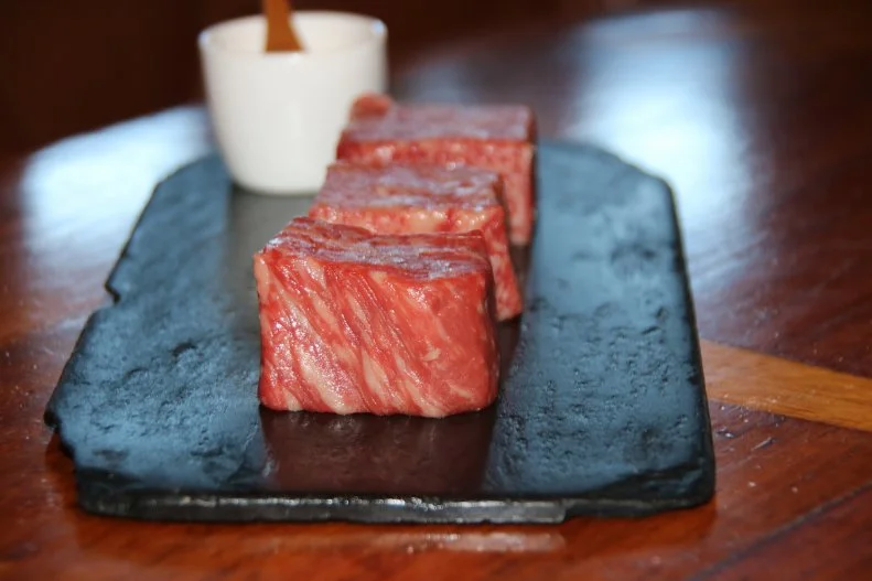 San Francisco's Epic Steak doesn't hold back. In-the-know diners kick off time there at the upstairs Quiver Bar with views of the Bay for the Holy Cow! Happy Hour, before heading down to get serious with some seriously decadent meat, in six-ounce portions. Their Wagyu Flight is the beef experience of a lifetime — essentially a tour across Japanese prefectures to taste the diversity of their meticulously raised cattle. The Imperial Wagyu uses cows who've developed for at least 400 days, Miyazakigyu A5 has the tightest marbling of the lot, and their Snow Beef A5 comes from the northern-most point of Japan in Hokkaido, raised in freezing conditions which result in an extra-low melting point. It'll set you back $180, but it’s a trip across Japan on a plate.