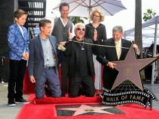 Chef Guy Fieri (C) reacts as his Hollywood Walk of Fame Star is unveiled in Hollywood, California on May 22, 2019, where Fieri received the 2,664th Star in the Category of Television while joined by his family, actor and fan Matthew McConaughey and Kathleen Finch (L), chief lifestyle brands officer at Discovery. (Photo by Frederic J. BROWN / AFP)        (Photo credit should read FREDERIC J. BROWN/AFP/Getty Images)