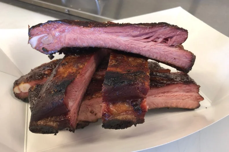 Winters in Big Sky Country are notoriously tough, so when Bozeman locals see the Blue Smoke Barbeque truck come summer time, there’s guaranteed to be a line. They’re likely to smell the truck even before they spy the plume of the trademark blue smoke, when the air is redolent of wood-fired sizzling ’cue. Chef-owner Justin Koller smokes locally sourced meats in the style of Texas barbecue, so beef brisket, smoked over a combination of imported Texas oak and local apple and cherry woods, is a prominent feature. There are also the requisite ribs and pulled pork, but Koller’s personal favorite are the whole chickens, which he brines in a local IPA before giving each the low-and-slow smoker treatment. Order a half or whole chicken, then take any leftovers home to make tacos or sandwiches. Given his chef pedigree, all sides and sauces are made from scratch; pair the brisket with a smoky sauce made from Bozeman Brewing Co.’s porter and smoked peppers and onions. You’ll find the truck posted up outside an old A&W drive-up restaurant in Three Forks, as well as at breweries and events in Bozeman.