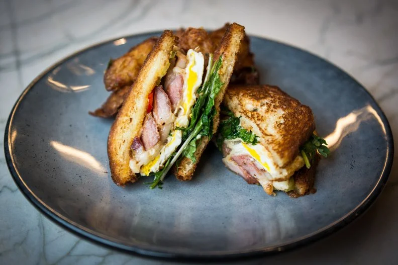 With its contemporary Art Deco motif, the sun-drenched corner of Marsh House at the base of the Thompson Nashville hotel is a buzzy daytime spot. It helps that the restaurant serves brunch every day — both hotel guests and locals can find their ideal midday meal here, whether that be Johnnycakes with salmon and crème fraiche or the Broken Yolk sandwich set between slices of brioche with belly ham, smoked onion, kale, and pickled peppers. Pastry chef Lisa Marie White melts hearts with her cast-iron cinnamon rolls and crème brûlée croissants. And, from Friday through Sunday, the offerings amp up with bottomless Champagne.