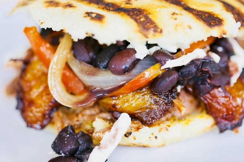 Lis Hernandez grew up in Venezuela watching her mother make arepas to sell on the street. The simple, soulful food — cornmeal patties charred on a hot grill, stuffed with all manner of tender meat and vegetables — has developed a serious following in Atlanta, first from Hernandez's stand in the Sweet Auburn Curb Market and later in her second location in Avondale Estates. Now her patrons line up for seating in her charming dining room and on the patio, where she serves more than a dozen kinds of arepas. Favorites include pernil (12-hour roasted pork and caramelized onions), perico (Venezuelan-style scrambled eggs, tomato and queso de año) and domino (black beans, queso de año, roasted red peppers, caramelized onions and fried sweet plantains). Looking for something lighter? Don't miss the avocado and heart of palm salad dressed with olive oil and sweet corn juice.