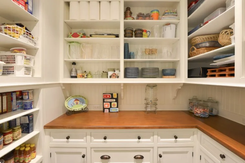 The existing butler's pantry in this 1980s home was divided into a new butler's pantry and this dry pantry. The dry pantry maximizes storage space off the kitchen, offering room for food and dishes alike.