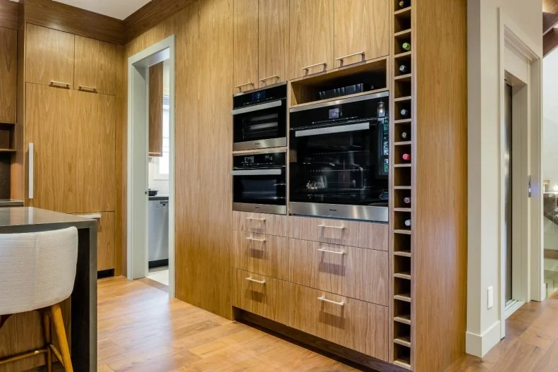 All the appliances in the kitchen are by chef-quality Miele. And to further delight the family chef, neat stacked cutouts perfectly fit a wine bottle.