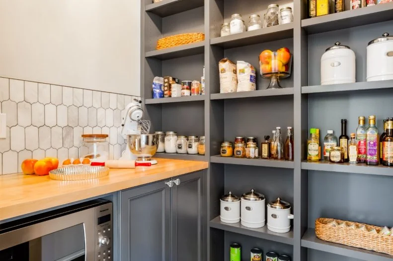 A spacious pantry was created by removing a washer and dryer from the kitchen, and instead adding on a separate laundry room.