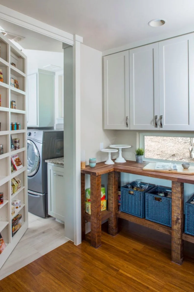 Doing laundry is ever so much more exciting when you get to come into the laundry room via a hidden entrance. Turn these pantry shelves around and step inside. The pantry itself features  hand-scraped shelves and a mahogany butcher block countertop.