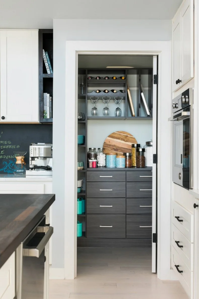 The extra pantry storage space helps keep this contemporary kitchen’s sleek counters free from clutter. 