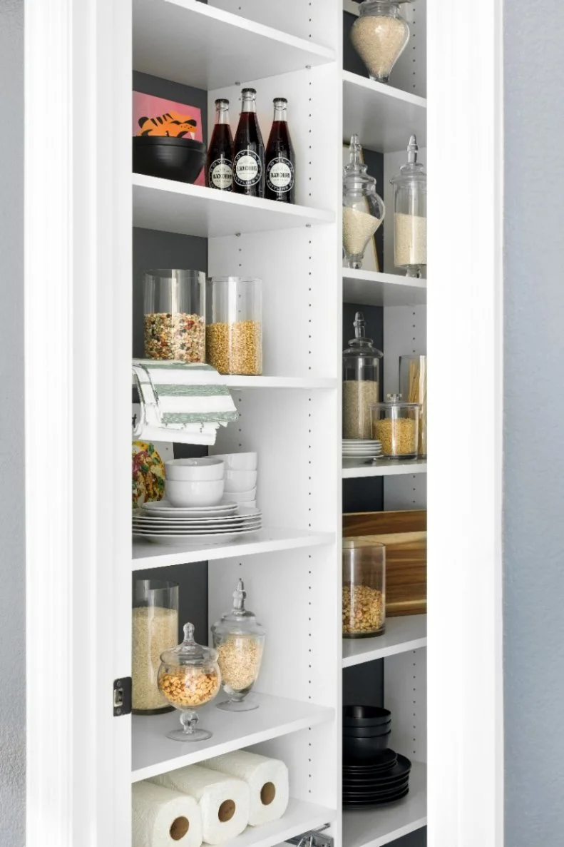 The walk-in pantry includes handy open shelves ideal for storing rolls of extra paper towels, snacks, bottled beverages, kitchen linens and more. 