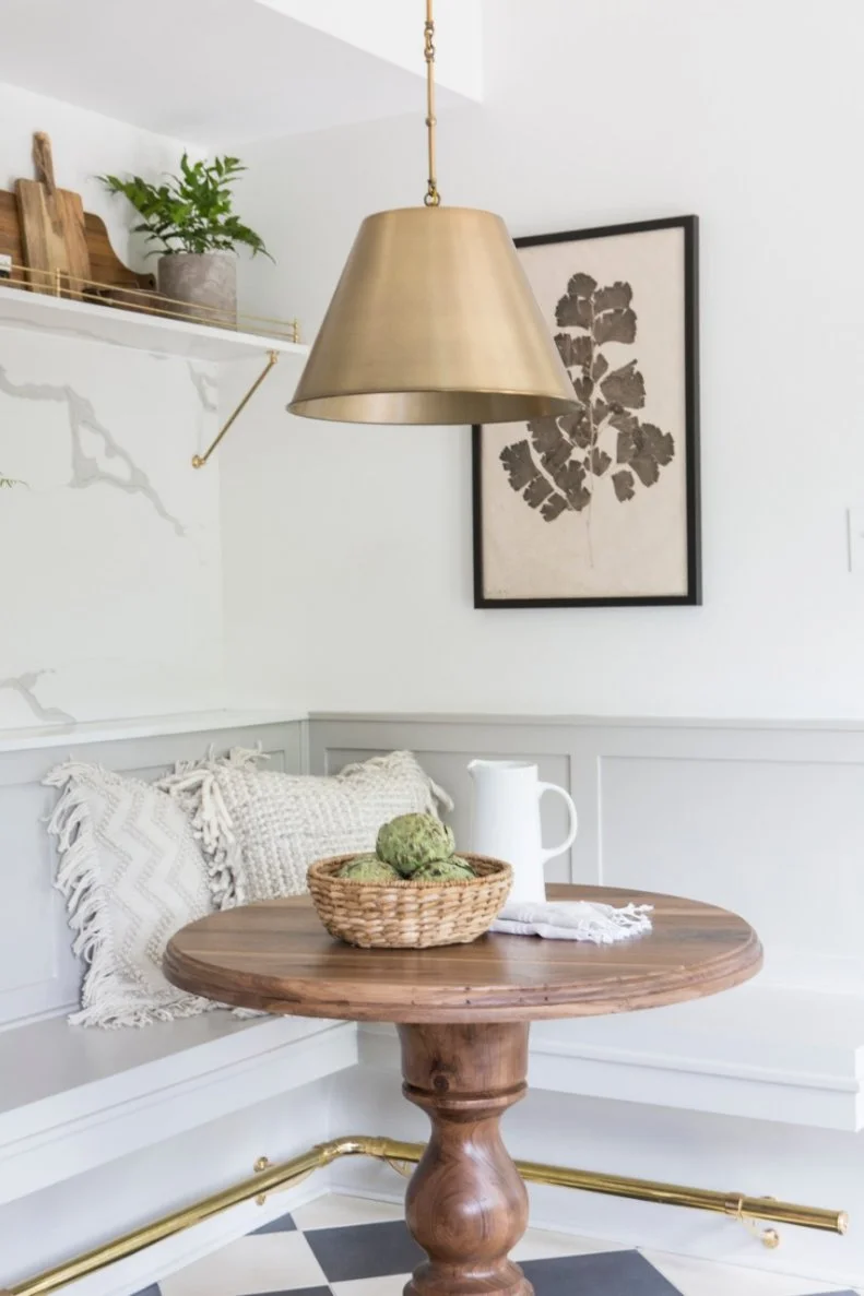 The breakfast nook features a solid walnut bistro table with pedestal base custom made by furniture artisan Clint Harp.