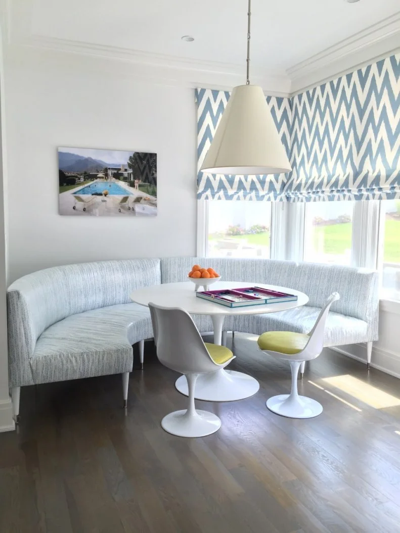 To maximize the seating in the eating nook in this kitchen, designers installed unique benches that surround the circular table. These benches can be moved and rearranged when the homeowners desire, creating a customizable space. 