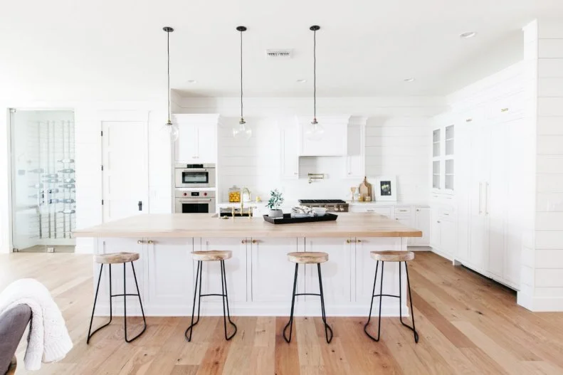 To give the homeowners an additional dining option, designers added four barstools to the kitchen island. This space can function as a breakfast bar for the family or as overflow seating from the breakfast nook when they entertain friends and family. 