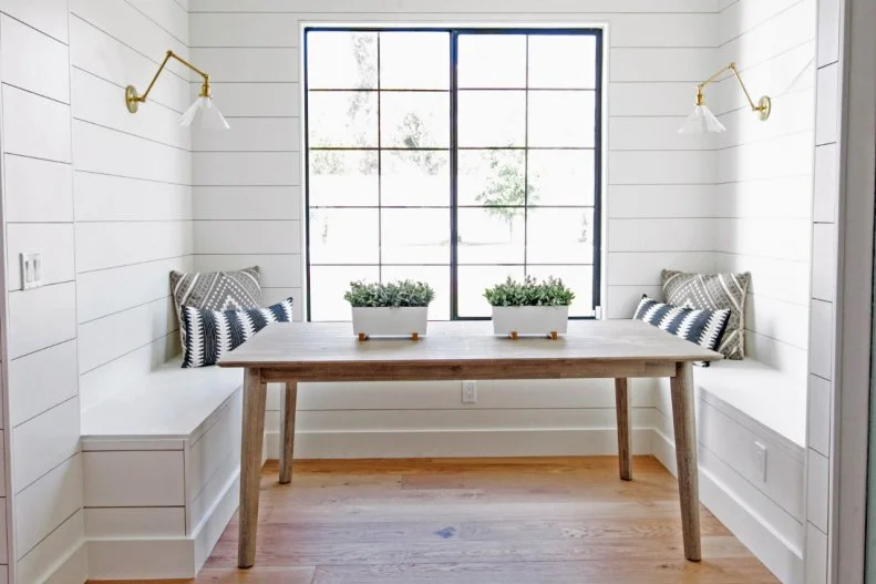 The breakfast nook to the side of the kitchen gives the homeowners an additional dining option. With benches on three sides and room for chairs on the other, this nook makes great use of its space, providing seating for at least six diners. 