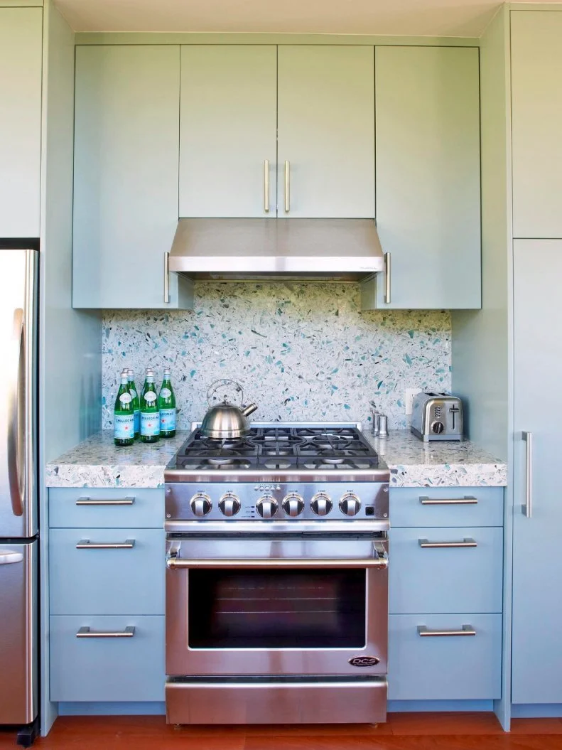 Designer Massucco Warner Miller chose terrazzo, concrete mixed with small bits of recycled glass, to create a sea-glass-inspired, eco-friendly kitchen backsplash. 
