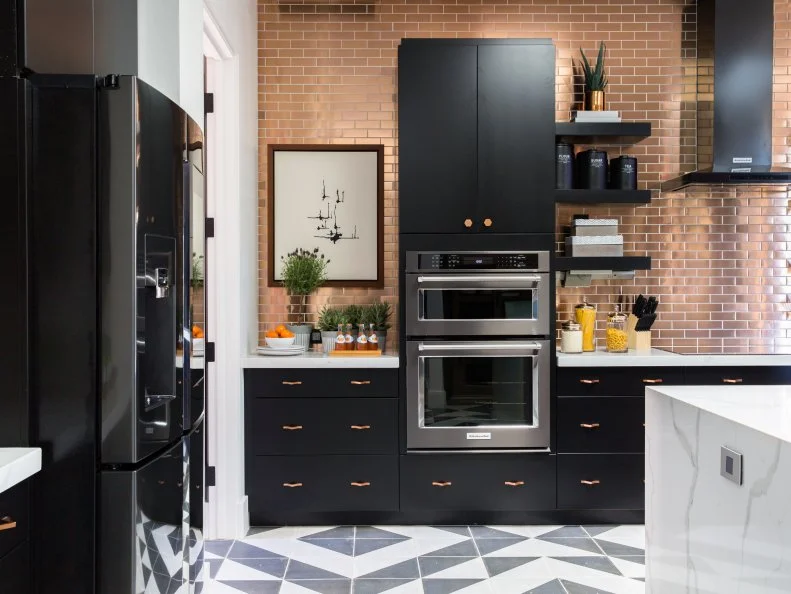 This view shows the open kitchen looking from the hallway that leads to the laundry room and three-car garage.