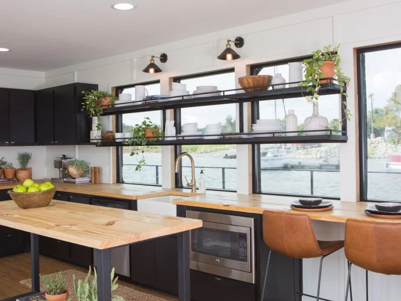 Wall-to-wall windows spanning the entire length of the kitchen bring in lots of natural light and afford wraparound views.