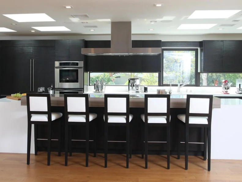 "People are having 'stainless steel fatigue' so we are paneling all of the appliances so they disappear and make the space look larger," says Christopher Grubb. Grubb predicts more wood tones and less gray and white for cabinetry over the next year.