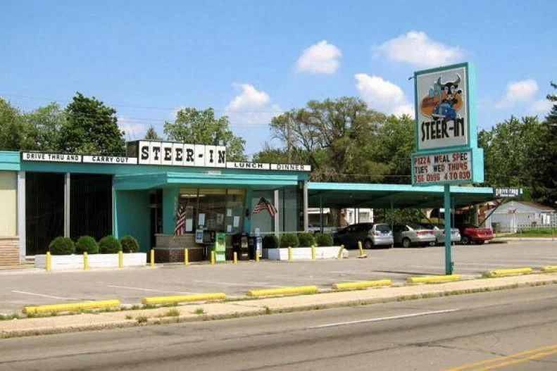 Part of the fun of road tripping is in uncovering unexpected bits of history. Museums and monuments are crucial, but sometimes tasting a bite of a city's past is just as important. For an old-school meal built for the road, you can't beat a drive-in. Steer-In launched in 1960 and has had some ups and downs, closing temporarily in 2007 before being resurrected by a family with a mission to preserve the East Side traditions like the Twin Steer, a double patty drenched in their signature Steer-In sauce that's regularly been crowned one of the best bites in the city.