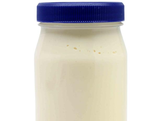 "A jar of mayonnaise, isolated on white."
