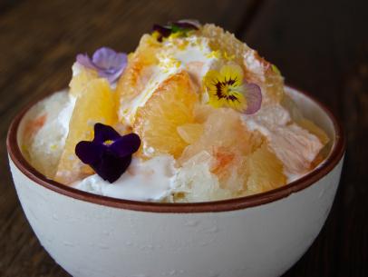 Part cocktail, part beautifully composed dessert, this pisco shaved ice is the perfect way to cool down in the California sun. To make it, a pisco sour (lemon juice, egg white, pisco and simple syrup) is frozen in an ice machine. Once frozen, it's shaved and combined with a light meringue, chunks of fresh, tangy grapefruit and a touch of lemon zest. The dessert is topped with edible flowers for a finishing touch.