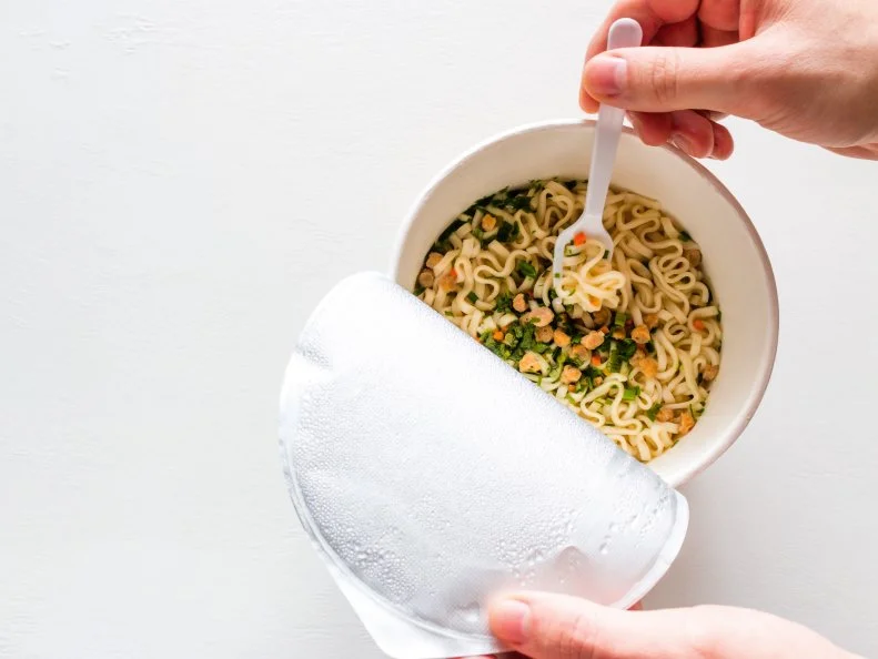 eating noodles on a white background with space for text.