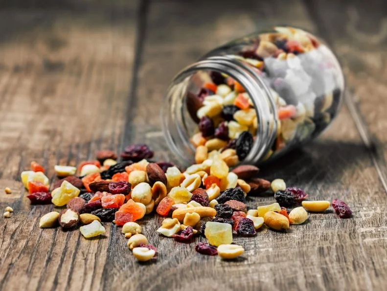 Trail mix in a jar on wooden background