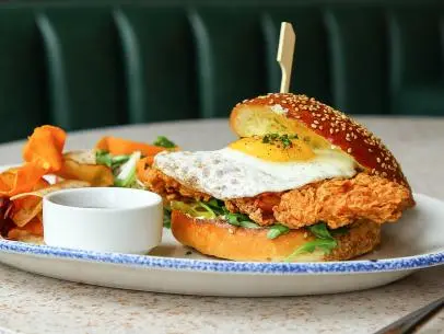 The massive West Hollywood hotspot Catch is a celebrity magnet as well as a great place for brunch. Book one of the restaurant's 340 seats and try the Chick N' Egg Sandwich with a sunny-side-up egg, organic crispy chicken, caramelized onions, pickles, arugula and herb mayo. Enjoy the see-and-be-seen atmosphere over some champagne, one of the best pairings possible with fried chicken.