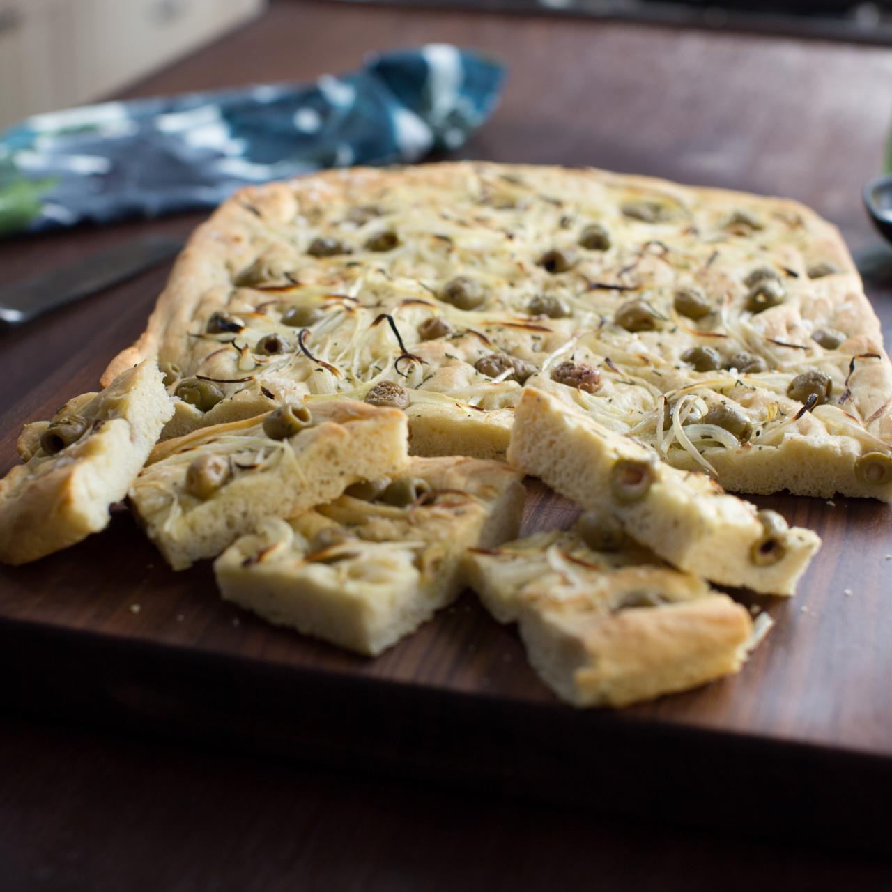 https://food.fnr.sndimg.com/content/dam/images/food/fullset/2019/6/25/0/VB0910_Olive-and-Rosemary-Focaccia_s4x3.jpg.rend.hgtvcom.1280.1280.suffix/1561587856839.jpeg