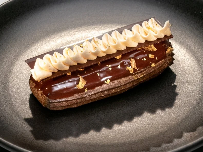 Contestant Joshua Livsey's dish is Mocha caramel Reclair, during the Skills Challenge, as seen on Best Baker in America, Season 3.