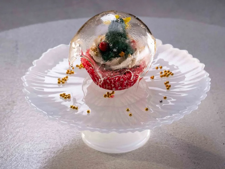 Contestant Claire Bueno's dish is It's a Wonderful Christmas, with gingerbread cupcake with a cranberry orange liqueur filling topped with a ginger Swiss meringue buttercream frosting, during the first challenge, as seen on Cupcake Championship, Season 1.