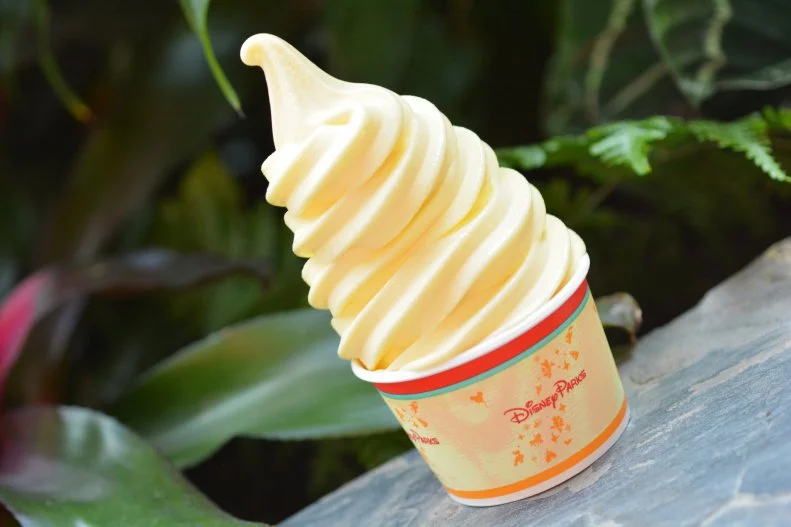 You never heard of the Tiki Juice Bar? Neither did we – until we sought out the source of Dole Whip®. As it turns out, this frosty, silky, sweet and tangy soft-serve wonder does, indeed, have a home with a name. It’s a little counter outside the Enchanted Tiki Room. In true Adventureland style, the Dole Whip is tropically flavored with pineapple. Even better, this creamy, luscious frozen treat is entirely dairy-free. We like a simple swirly cone-full, but we do see fellow Mouseketeers enjoying a Dole Whip Float. That has pineapple juice and the soft-serve. More disciplined guests order only the pineapple juice, which is also refreshing.