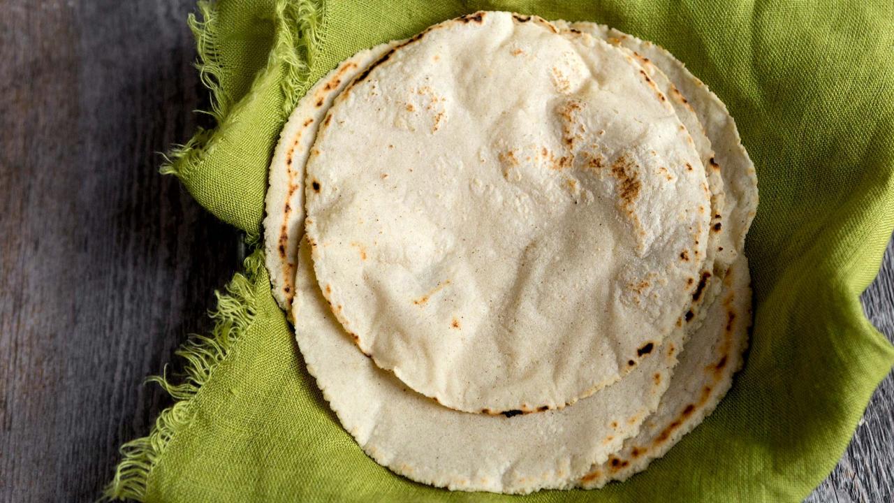 Fresh handmade corn tortillas cooking on the comal for dinner.
