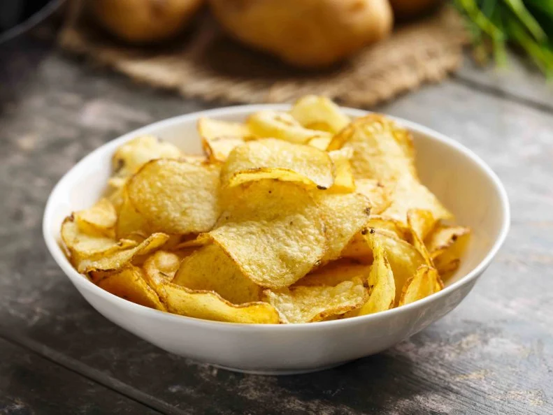 Hearty kettle cooked potato crisps served in a bowl.