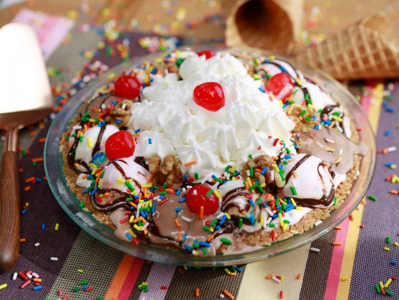 The hosts work together to Pass the Grilled Banana Split Pie, as seen on Food Network's The Kitchen