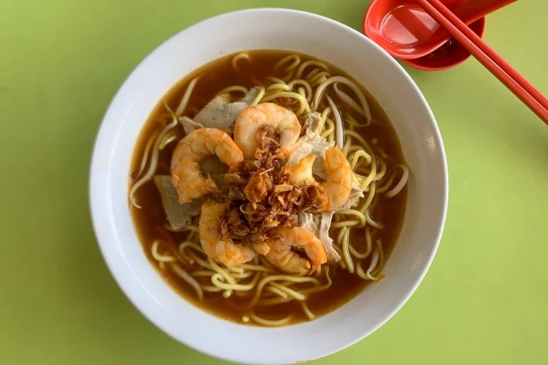 Li Ruifang quit her corporate job to take over her father’s hawker stall and keep their famous prawn noodle recipe alive. By 2:30 a.m., Ruifang is already prepping the noodles, shrimp and rich broth. This must-visit stall is open Mondays to Fridays from 6:30 a.m. to 2 p.m. or earlier if they sell out. You can spot this third-generation hawker stall by its long line in Tekka Centre.