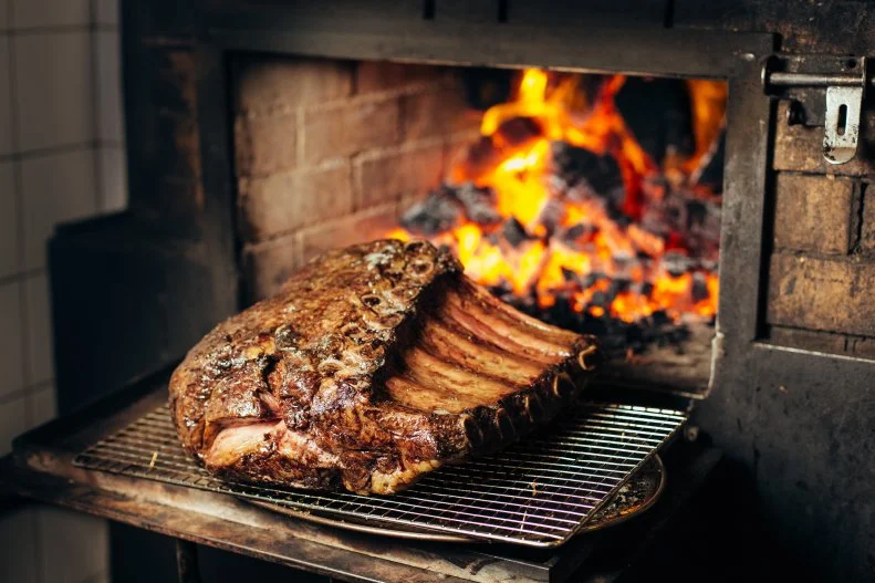One of the hottest restaurants in Singapore, Burnt Ends is helmed by grill-loving Australian chef Dave Pynt who designed his own two-oven brick kiln. This means incredible steaks, seafood and vegetables cooked over coal and apple or almond wood for maximal flavor. The open-concept kitchen means you’ll also get a front-row seat to a show when they’re grilling up your 75-day aged Blackmore OP Rib (or bone-in rib-eye).