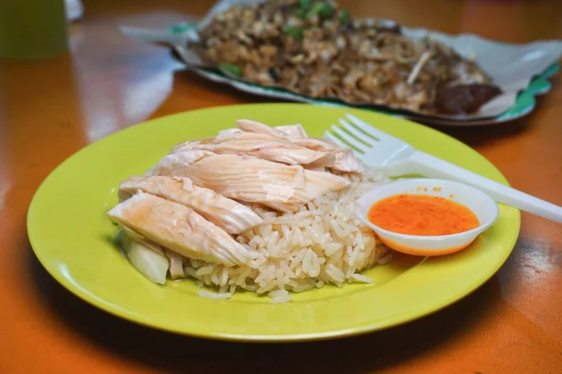 Celebrities and dignitaries of all ilk flock to this famous Hainanese chicken rice stall to try one of Singapore’s most-beloved dishes. Located inside the popular Maxwell Hawker Centre, you can spot the stall by its massive line. The chef here has perfected the aromatic chicken rice, cooking the grains in chicken stock, with tender strips of perfectly steamed chicken, spicy chile sauce and soy sauce to balance it.