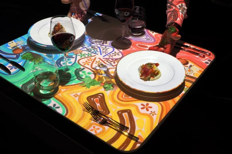 When Celebrity Cruises’ Celebrity Edge debuted in 2018, it marked an overhaul for the line from bow to stern, including cuisine changes for the long-time food-focused line. That’s especially true at the dimly lit Le Petit Chef and Friends experience at Le Grand Bistro. Fusing fine cuisine and entertainment, the tabletops themselves come to life for dinner through a partnership with TableMation Studios featuring Skullmapping’s world-famous Le Petit Chef, an animated 3D character who appears on diners’ plates and “prepares” the courses right before their eyes.